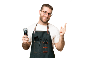 Barber man in an apron over isolated chroma key background showing and lifting a finger in sign of the best