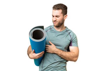 Young sport man going to yoga classes while holding a mat over isolated chroma key background with sad expression