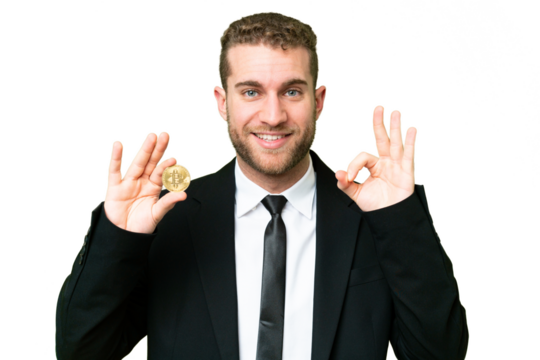 Young business blonde man holding a Bitcoin over isolated chroma key background showing ok sign with fingers