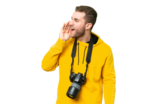 Young photographer man over isolated chroma key background shouting with mouth wide open to the lateral