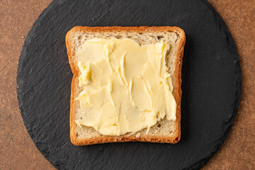 Butter that adds flavor to meals and is for breakfast on black  background
