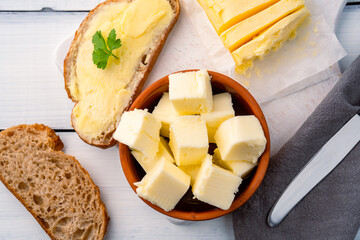 Butter that adds flavor to meals and is for breakfast on white wooden  background