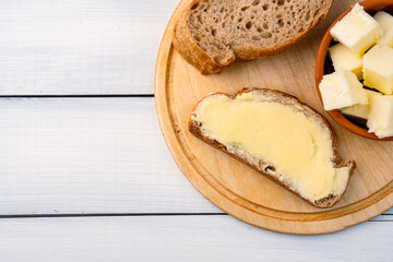 Butter that adds flavor to meals and is for breakfast on white wooden  background