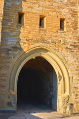 This dark passageway through the ancient castle walls evokes a sense of mystery, leading to hidden...