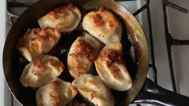 Frying "pierogi ruskie". Traditional polish dumplings filled with cheese and potatoes.