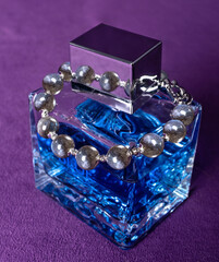 Graceful labradorite bracelet on the perfume bottle.
