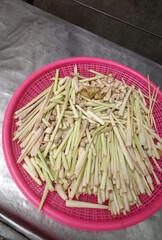Cutting lemon grass in pink basket
