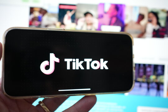 Roosendaal, The Netherlands - February 2, 2025: Person holding a mobile phone displaying the logo of  TikTok,  a personalized video content and entertainment platform from China.