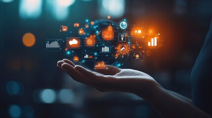 Businessman's hand holding a digital, glowing planet with business icons on a dark background, an AI and technology concept for online marketing and global connection. Copy space available. 