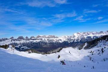 Naklejka premium Scenic snowy landscape with Churfirsten mountain peaks in the background at Swiss ski resort Flumserberg on a winter day. Photo taken January 29th, 2025, Flumserberg, Switzerland.