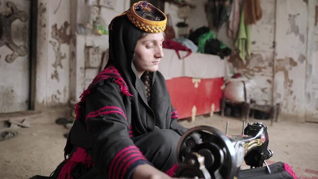 Portrait Young Kalashi Young Woman, Traditionally Dressed girl Sewing a Dress in Kalash Valley, Chitral, Pakistan.
