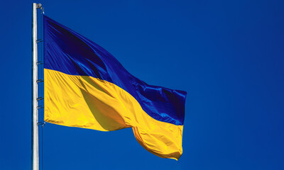 Flag of Ukraine on a flagpole. Blue and yellow colors. National symbol of the country.