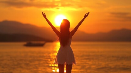 Fototapeta premium Sunset Serenity: A Woman Silhouetted Against the Golden Horizon
