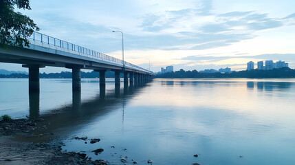 Calm dawn over river bridge, city skyline background; tranquil travel scene