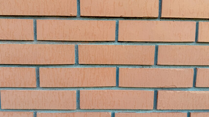 Obraz premium Close-up of a red brick wall symbolizing construction, strength, and homebuilding dynamics, suitable for architecture concept themes