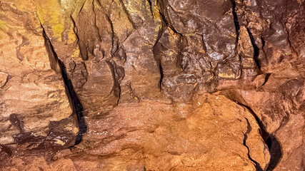 Rugged texture of a natural cave wall, showcasing geological formations and adventure exploration concepts