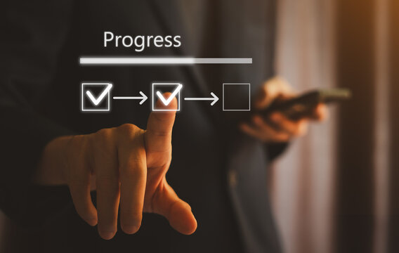 Businessman touch to mark the correct in the checklist with continuous loading status to remind the progress tasks of project development, management and concept tracking.