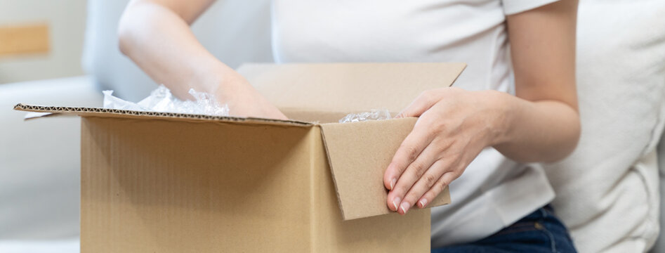 person unboxing package shopping online via internet at home