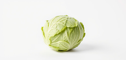 Fototapeta premium A whole, fresh green cabbage sits on a clean, white surface. Its tightly packed leaves exhibit a crisp texture and vibrant color, emphasizing its freshness and quality