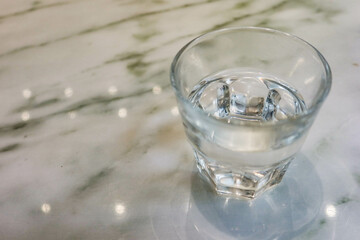close up of transparent glass of water on a marble table