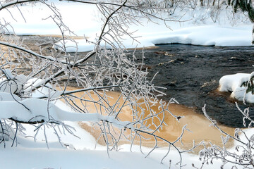 Winter frosty northern landscape by the river with pure white snow