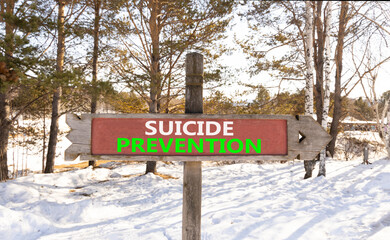 Suicide prevention symbol. Concept words Suicide prevention on beautiful wooden road sign. Beautiful snow forest background. Psychological and suicide prevention concept. Copy space.