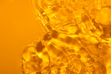 Bright Yellow Liquid Surface with Bubbles and Ripples in Water