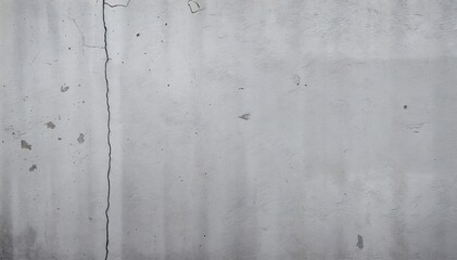 textured wall with prominent crack running vertically down surface wall shows signs of age and weathering with various discolorations and imperfections