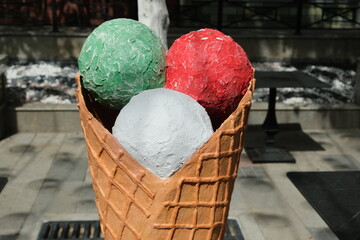 street decor in the form of multi-colored ice cream balls in a waffle cone