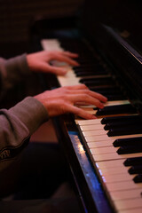Obraz premium Close up shot of a piano keys, pianist, man is playing a piano