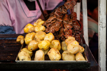 anticucho with heart meat and potato on the streets of the city of la paz bolivia - street food...