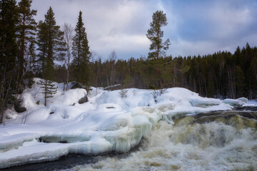 Winter landscape with a waterfall and snow. Russia, Karelia