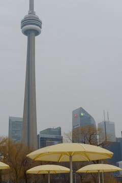 yellow umbrellas at HTO Beach, freestanding landmark tower, and TD Terrace in Toronto, Canada (winter)