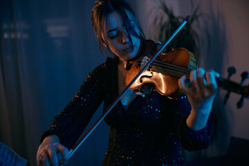 Fototapeta premium Female Violinist is Preparing for a Concert