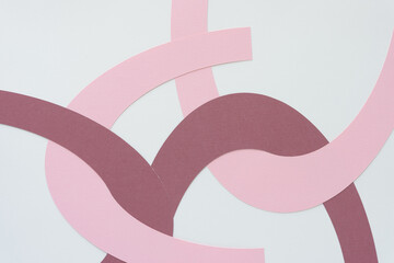 machine-cut pink and purple paper arcs on blank paper