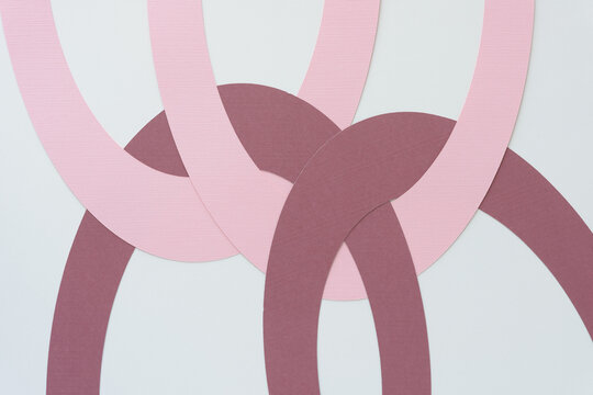 machine-cut pink and purple paper arcs on blank paper