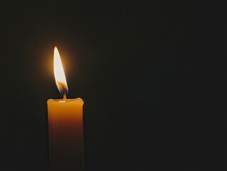 A single candle flame burning in the darkness isolated on black background, simple minimalistic aesthetic stock photo, high quality