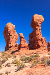 Fototapeta premium A rocky landscape with three large rock formations, each with a distinct shape