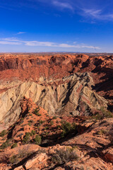 A mountain range with a blue sky in the background