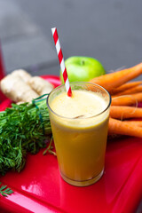 Healthy Juice with Apple, Ginger, and Carrot – Fresh Ingredients on Red Stool