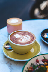 Cappuccino with Heart Latte Art – Yellow Cup and Plate at Paris Café