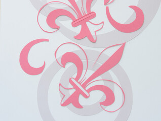 machine-cut dingbat fleur-de-lys shapes and concentric rings on blank paper