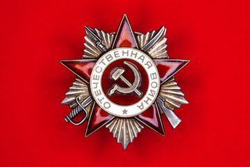 Soviet Order of the Patriotic War on a red background. Symbol victory in World War II. Translation...
