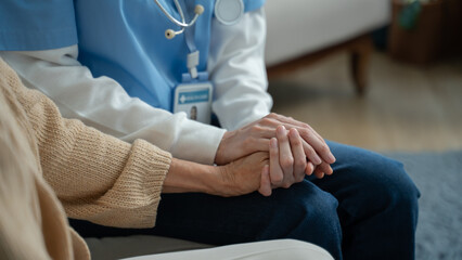 closeup hand of caregiver holding hands helping for comfort,trust or patient for medical check or nursing.Senior care,support or nurse holding hands for healthcare service,wellness or empathy,Sympathy