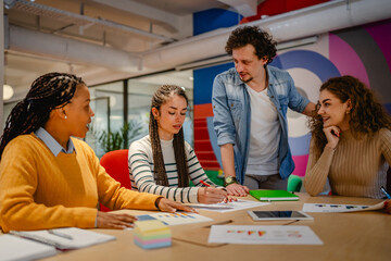 male and female colleagues research together in the office