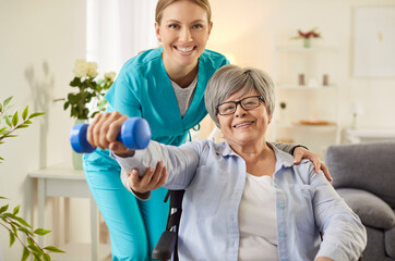 Senior rehabilitation, kind nurse helping with dumbbell exercises, doctor gives sport support to...