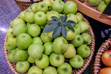 Fresh green apples in wooden basket ,delicious fruit.
