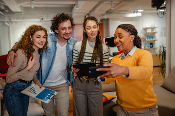 males and females multicultural colleagues watch mobile screen