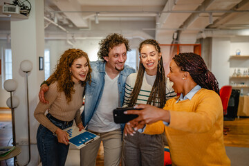 males and females multicultural colleagues watch mobile screen