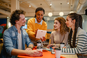 group of multicultural teamwork research together on tablet at office